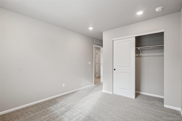 unfurnished bedroom with a closet and carpet