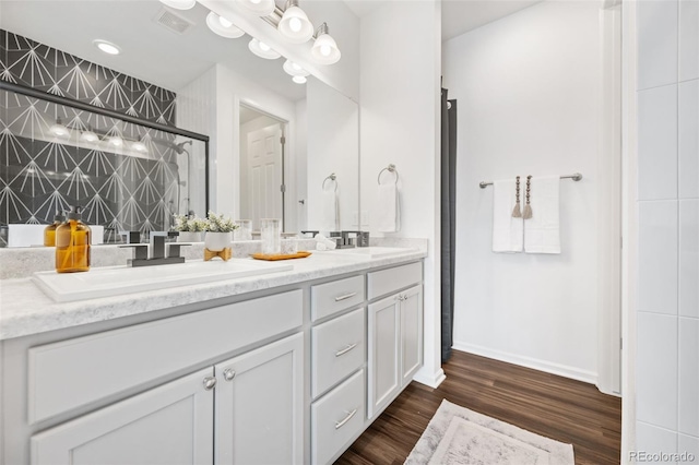 bathroom with vanity, wood-type flooring, and a shower with door