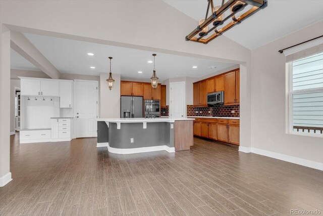 kitchen with appliances with stainless steel finishes, baseboards, decorative backsplash, light countertops, and recessed lighting