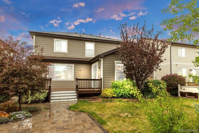 view of front of property with a front yard and a patio