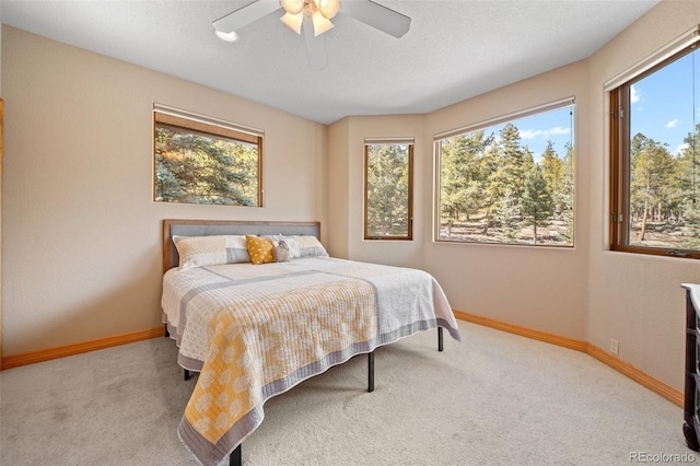 bedroom with baseboards, a ceiling fan, and carpet