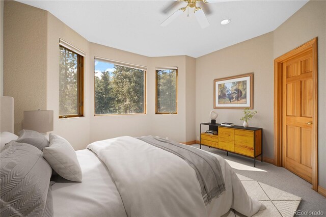 bedroom featuring baseboards, ceiling fan, and carpet