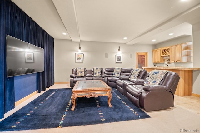 carpeted living room with a sink, baseboards, and recessed lighting