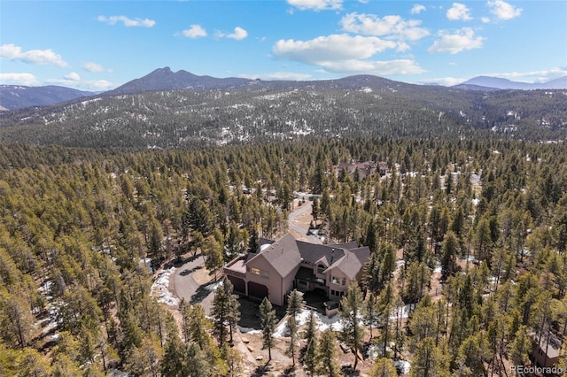 drone / aerial view with a mountain view and a forest view