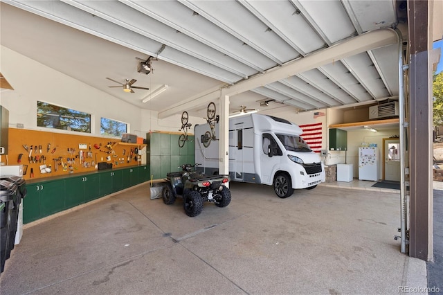 garage with freestanding refrigerator, a garage door opener, and ceiling fan