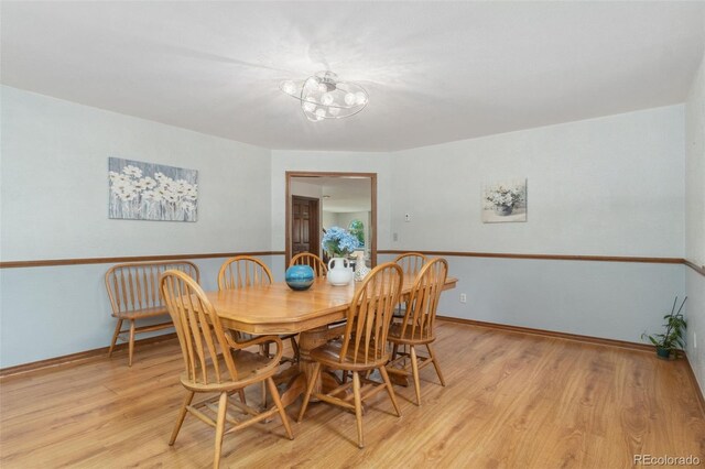 dining room with a chandelier and light wood-type flooring