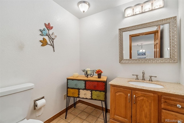 bathroom featuring toilet, vanity, and tile patterned floors