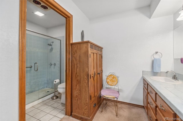 bathroom featuring vanity, walk in shower, tile patterned flooring, and toilet