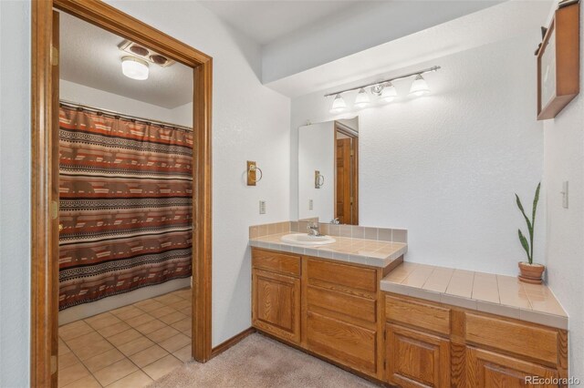 bathroom with vanity and tile patterned flooring