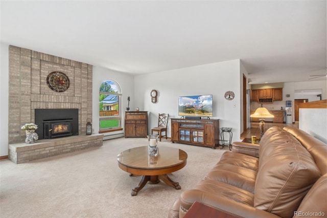 carpeted living room featuring a baseboard radiator and a fireplace