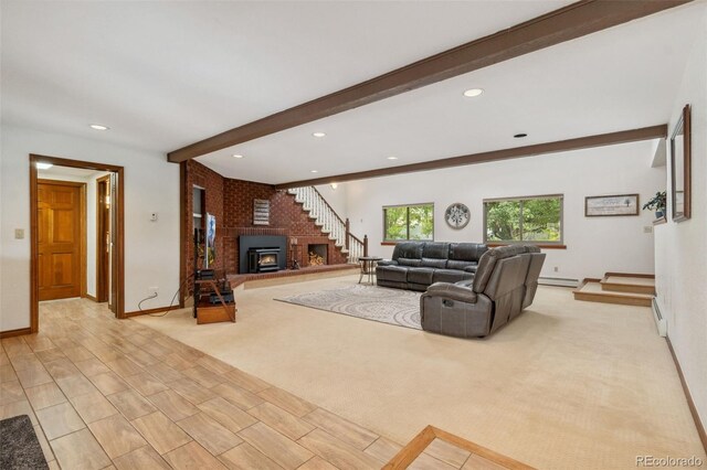 living room featuring a wood stove, a baseboard heating unit, light carpet, and beamed ceiling