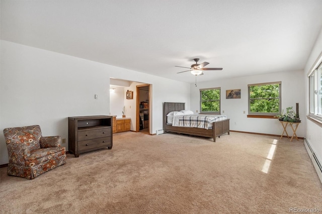 carpeted bedroom with ceiling fan and a baseboard radiator