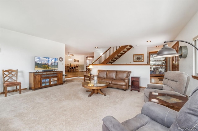 living room featuring light colored carpet and ceiling fan