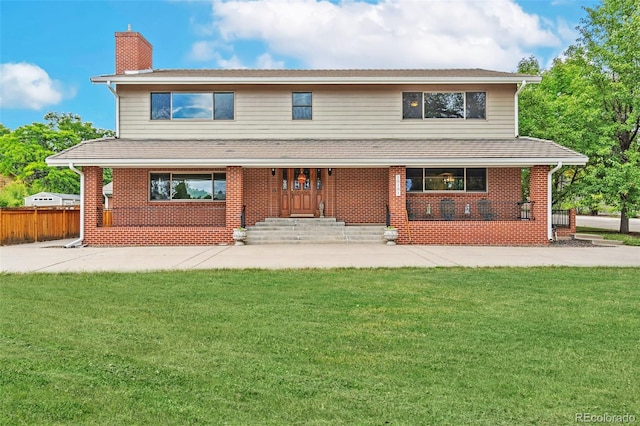 10101 W 72nd Ave, Arvada, CO 80005 - view of front of house with a chimney, brick siding, and a porch