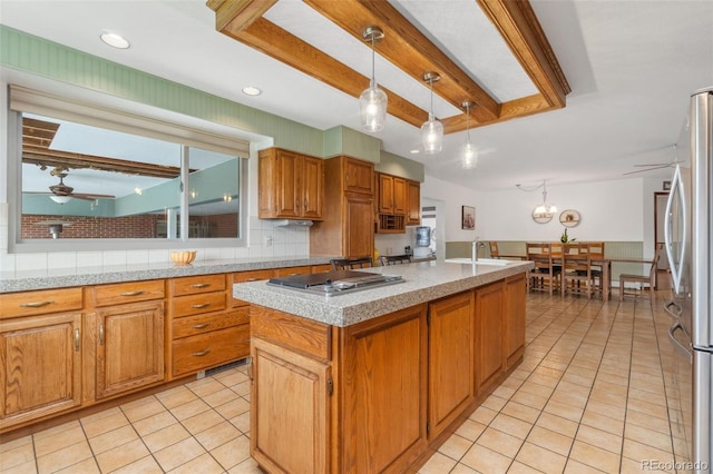 10101 W 72nd Ave, Arvada, CO 80005 - kitchen featuring stainless steel appliances, light tile patterned floors, ceiling fan, beam ceiling, and hanging light fixtures