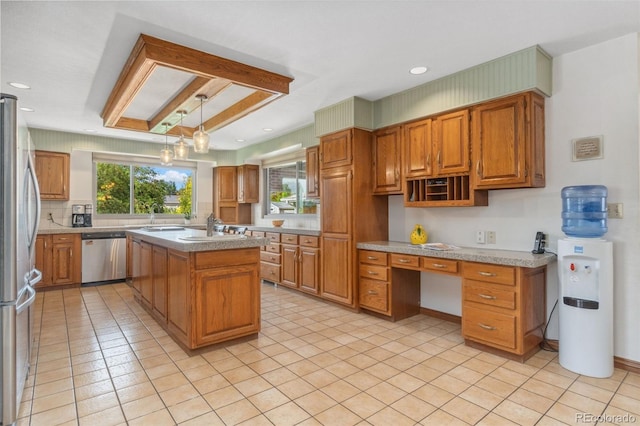 10101 W 72nd Ave, Arvada, CO 80005 - kitchen featuring appliances with stainless steel finishes, a sink, light countertops, brown cabinetry, and a kitchen island with sink