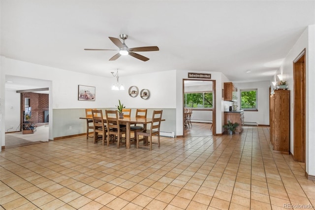 10101 W 72nd Ave, Arvada, CO 80005 - dining area with a baseboard radiator, a ceiling fan, baseboards, and light tile patterned floors