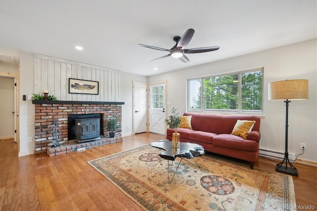 11457 Nancys Dr, Conifer, CO 80433 - living room featuring ceiling fan, wood finished floors, recessed lighting, and a wood stove