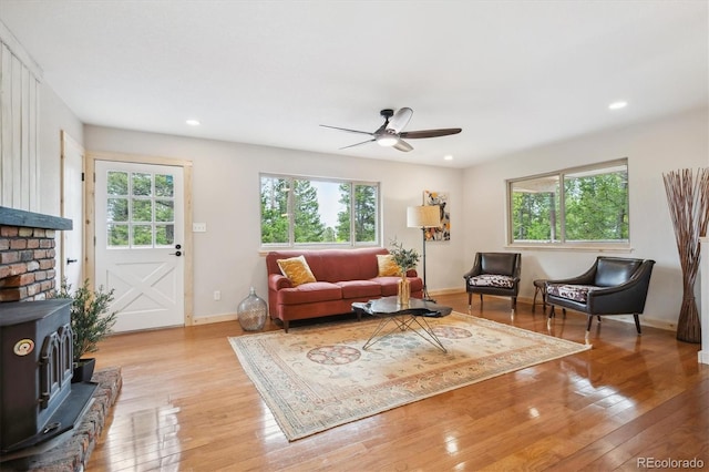 11457 Nancys Dr, Conifer, CO 80433 - living area with a wood stove, ceiling fan, light wood-style floors, and recessed lighting