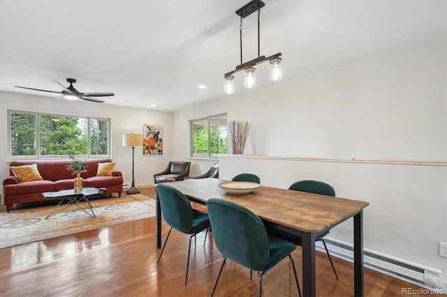 11457 Nancys Dr, Conifer, CO 80433 - dining space with baseboard heating, a ceiling fan, wood finished floors, and recessed lighting