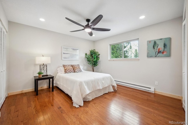 11457 Nancys Dr, Conifer, CO 80433 - bedroom featuring a baseboard radiator, light wood-type flooring, recessed lighting, a closet, and ceiling fan