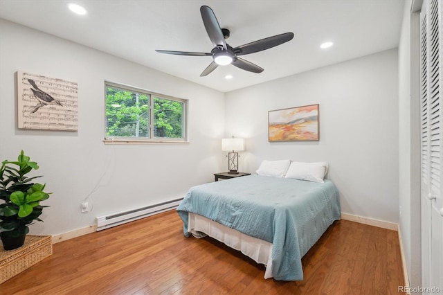 11457 Nancys Dr, Conifer, CO 80433 - bedroom featuring a baseboard radiator, wood finished floors, recessed lighting, and ceiling fan