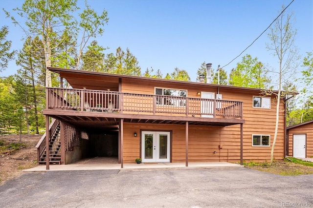 11457 Nancys Dr, Conifer, CO 80433 - rear view of property featuring french doors, a wooden deck, and stairs