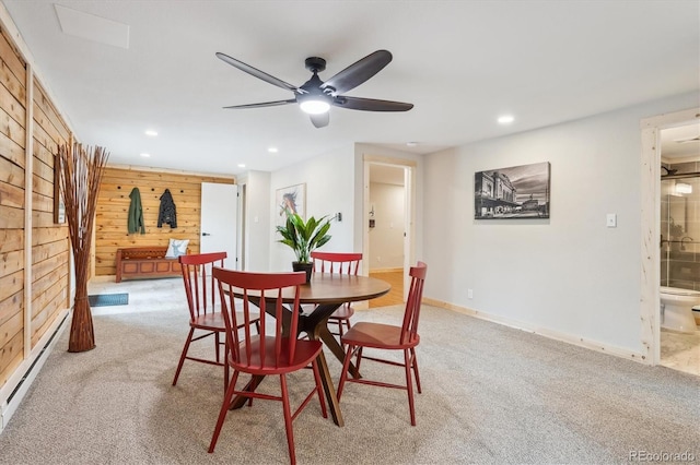 11457 Nancys Dr, Conifer, CO 80433 - dining space featuring baseboard heating, a ceiling fan, carpet flooring, recessed lighting, and wooden walls