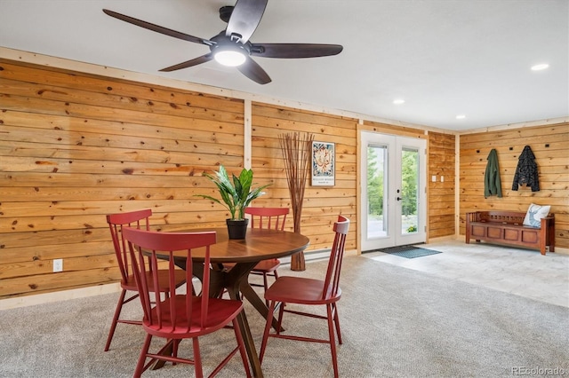 11457 Nancys Dr, Conifer, CO 80433 - carpeted dining area featuring wooden walls, french doors, ceiling fan, and recessed lighting