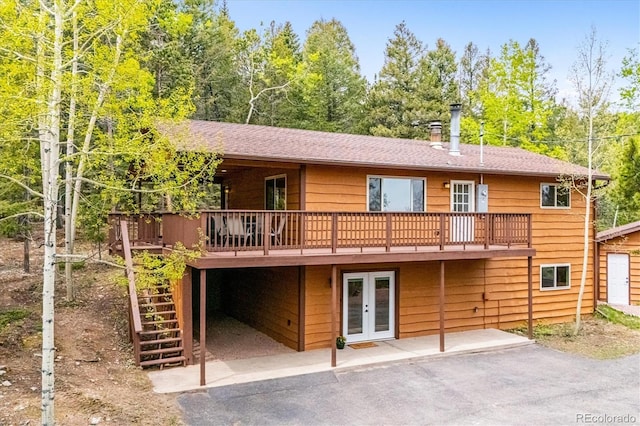 11457 Nancys Dr, Conifer, CO 80433 - back of property featuring french doors, a deck, stairs, and a patio