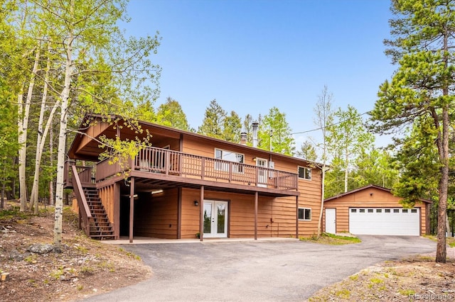 11457 Nancys Dr, Conifer, CO 80433 - chalet / cabin with french doors, a deck, an outbuilding, a garage, and stairs