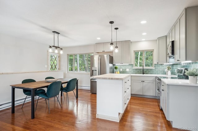 11457 Nancys Dr, Conifer, CO 80433 - kitchen featuring stainless steel appliances, a kitchen island, light countertops, plenty of natural light, and recessed lighting