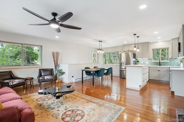 11457 Nancys Dr, Conifer, CO 80433 - living area with plenty of natural light, baseboard heating, light wood-style flooring, recessed lighting, and ceiling fan