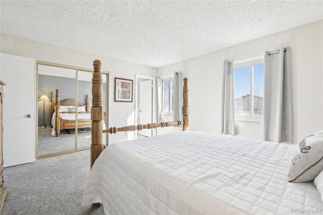 carpeted bedroom with a closet and a textured ceiling