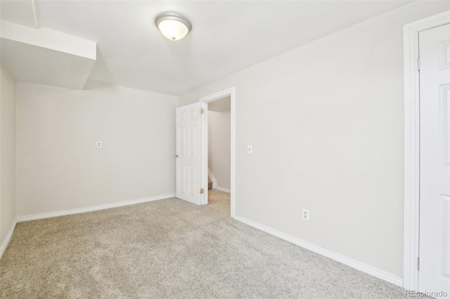 spare room featuring carpet flooring and baseboards