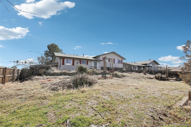 rear view of house with fence