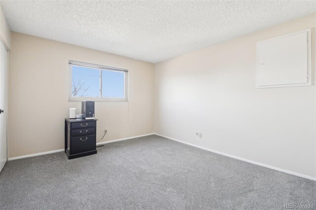 12097 E Mexico Ave, Aurora, CO 80012 - carpeted empty room with a textured ceiling and baseboards