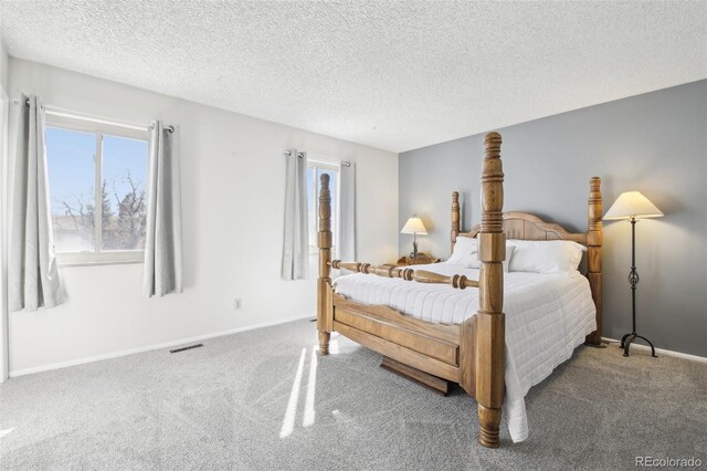 12097 E Mexico Ave, Aurora, CO 80012 - bedroom with carpet flooring, baseboards, and a textured ceiling