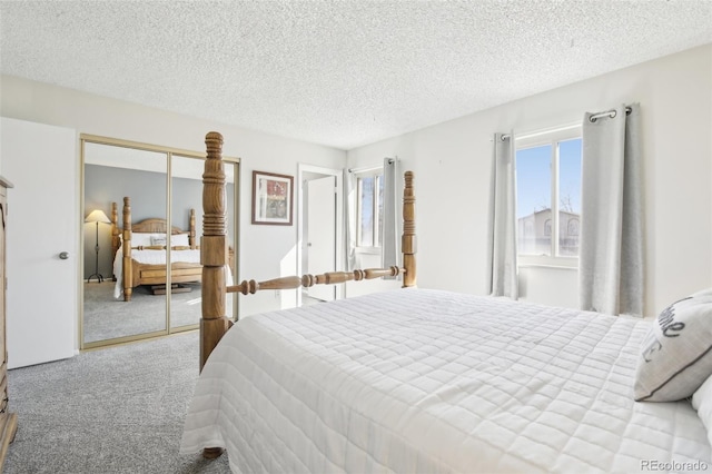 carpeted bedroom featuring a closet and a textured ceiling
