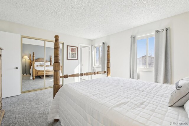 12097 E Mexico Ave, Aurora, CO 80012 - carpeted bedroom featuring a closet and a textured ceiling