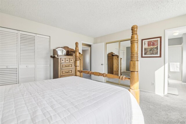 12097 E Mexico Ave, Aurora, CO 80012 - carpeted bedroom with a textured ceiling, multiple closets, and ensuite bath