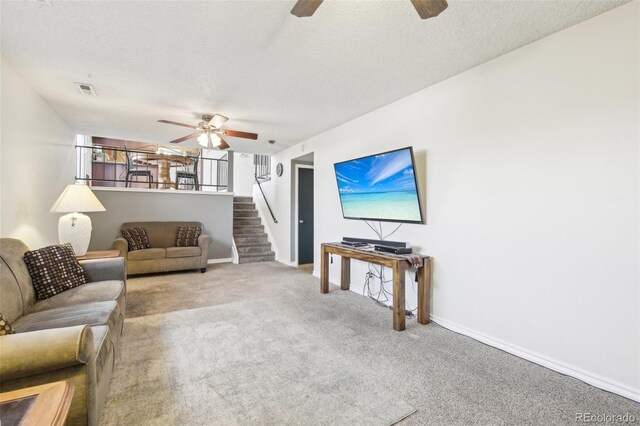 12097 E Mexico Ave, Aurora, CO 80012 - carpeted living area featuring ceiling fan, a textured ceiling, baseboards, and stairs