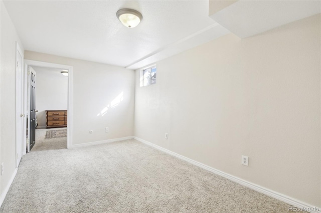 unfurnished bedroom featuring light carpet and baseboards