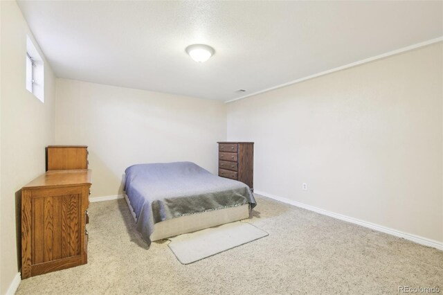 bedroom featuring carpet floors and baseboards