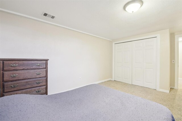 unfurnished bedroom with carpet, a closet, and baseboards