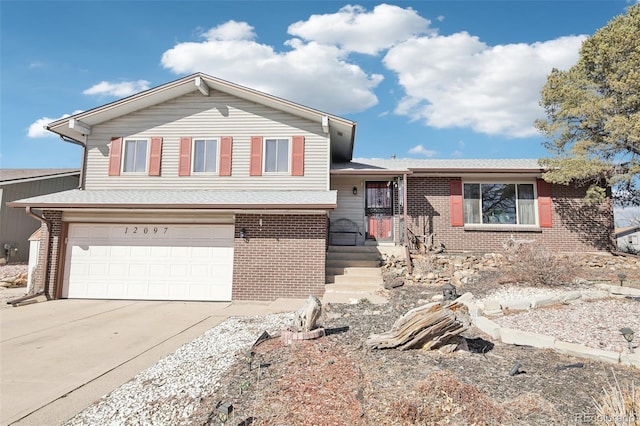 tri-level home featuring a garage, brick siding, concrete driveway, and a shingled roof