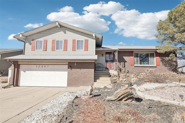 12097 E Mexico Ave, Aurora, CO 80012 - tri-level home featuring a garage, brick siding, concrete driveway, and a shingled roof