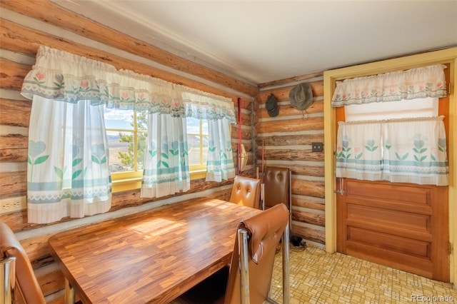 dining space featuring log walls