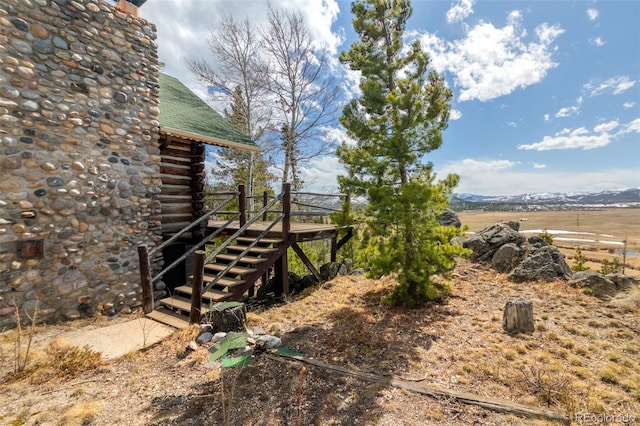 view of yard with a wooden deck and stairway