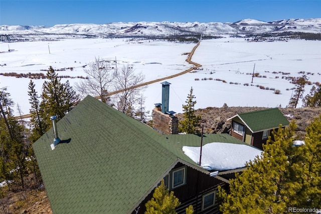 snowy aerial view with a mountain view